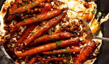 Spicy maple roasted carrots with crispy chickpeas with yogurt sauce on a plate